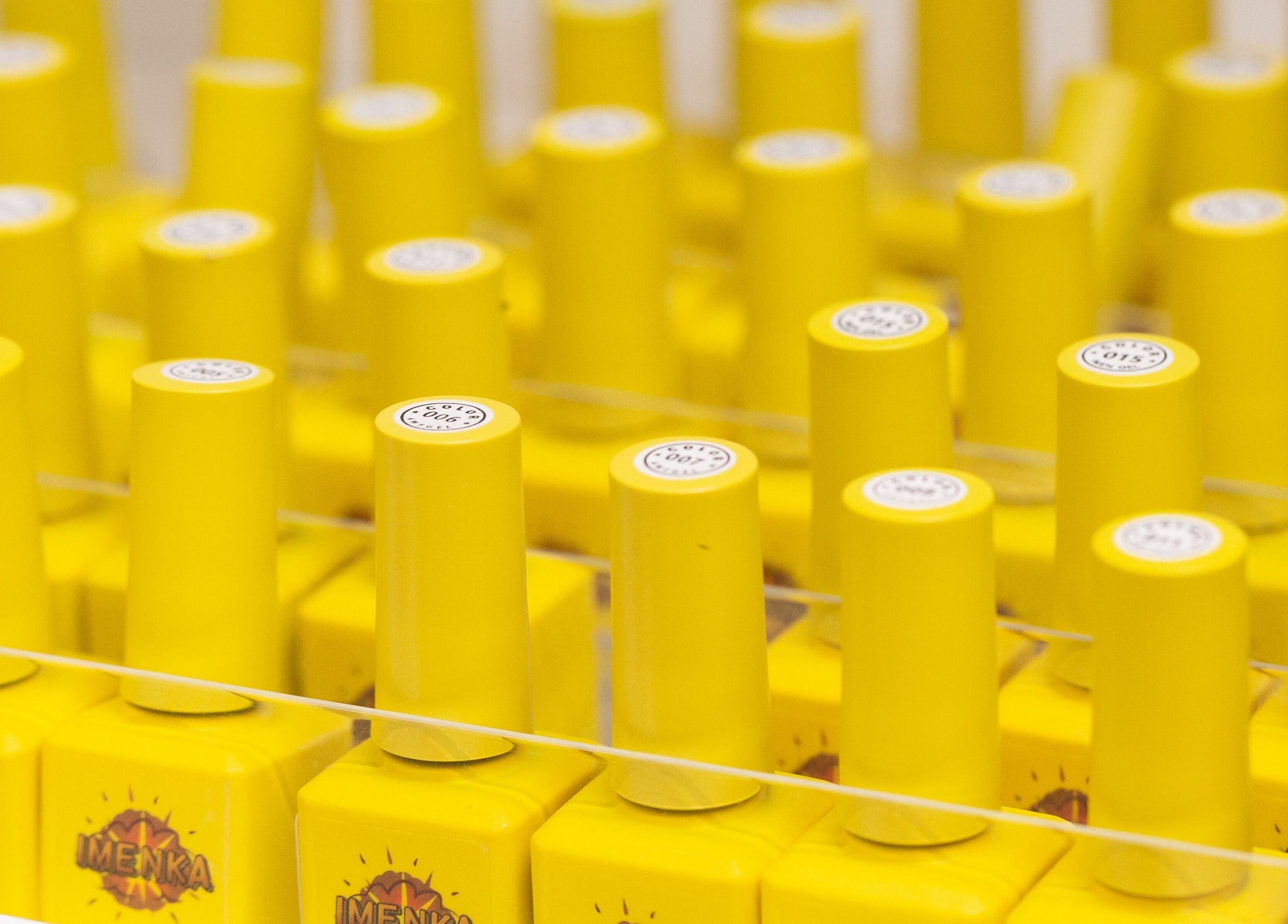 Bright yellow nail polish caps at Zaranailsnyc, New York, United States, US.