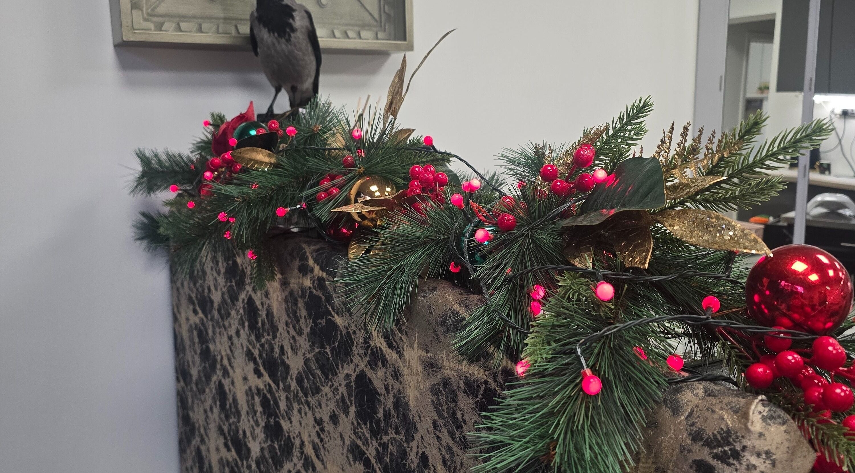Festive garland decor at Black Angels Beauty Salon, Gourock, Scotland, GB, featuring red baubles and greenery.