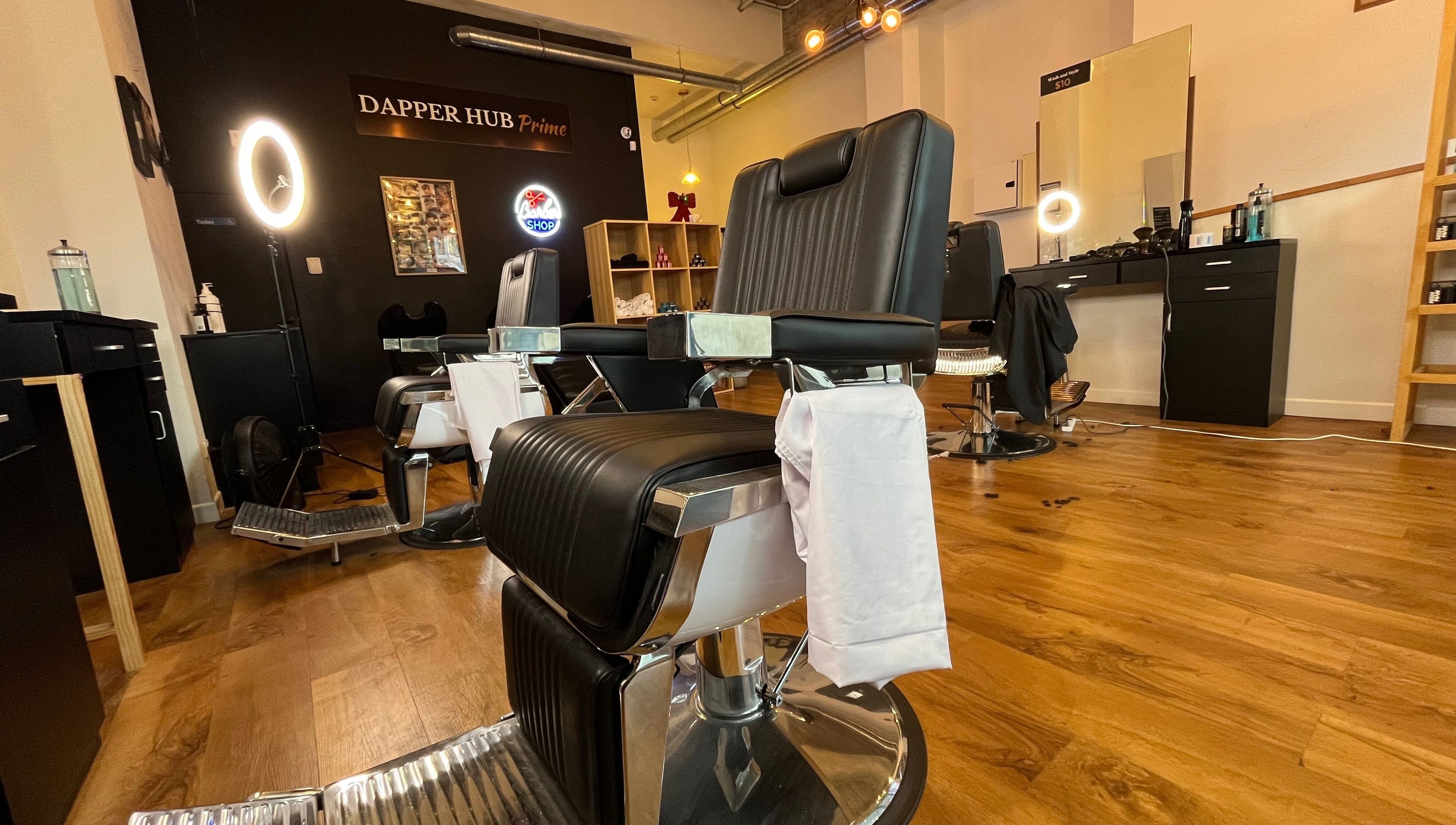 Interior of Dapper Hub Barbershop CBD in Auckland, Auckland, NZ showcasing stylish chairs and modern decor.