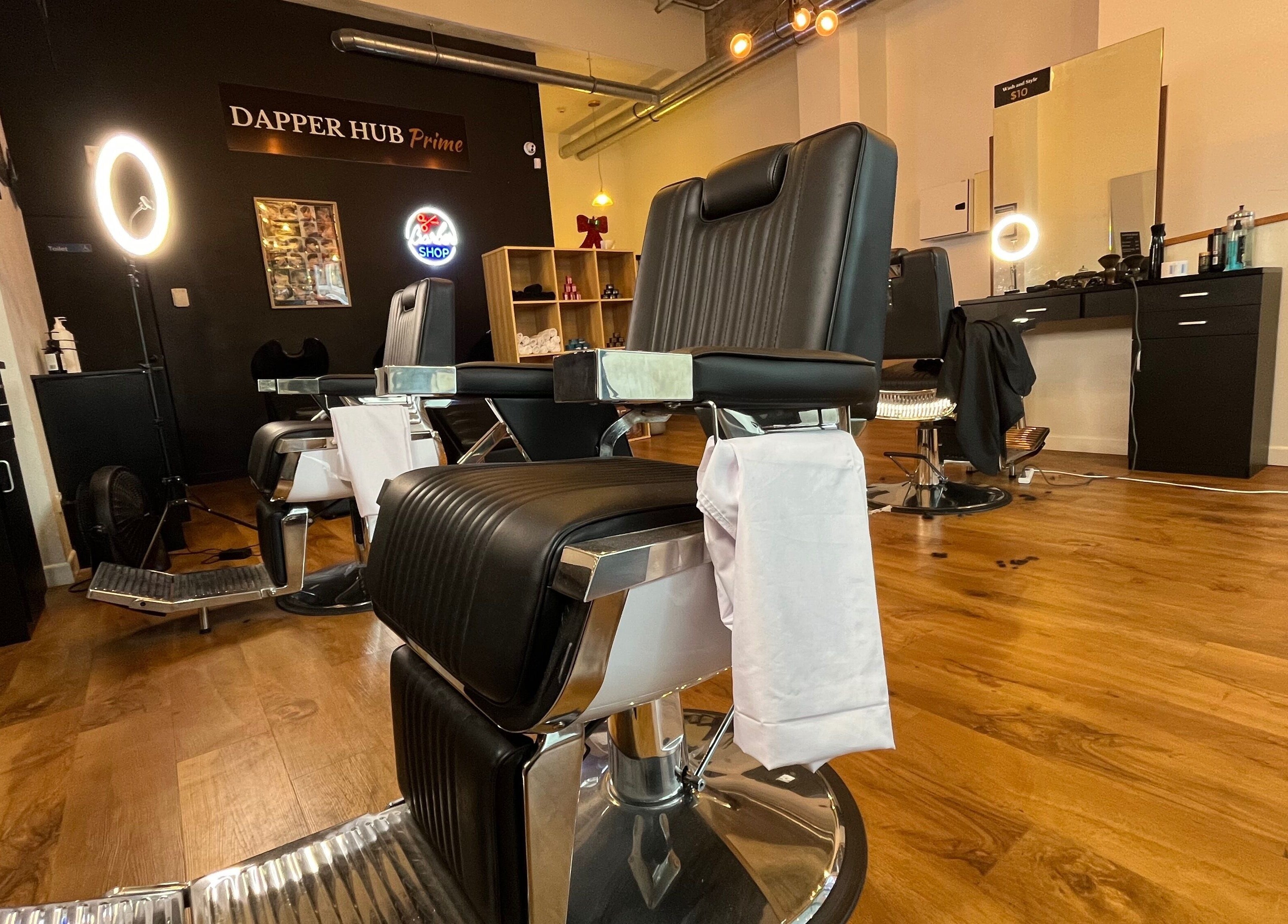 Interior of Dapper Hub Barbershop CBD in Auckland, Auckland, NZ showcasing stylish chairs and modern decor.