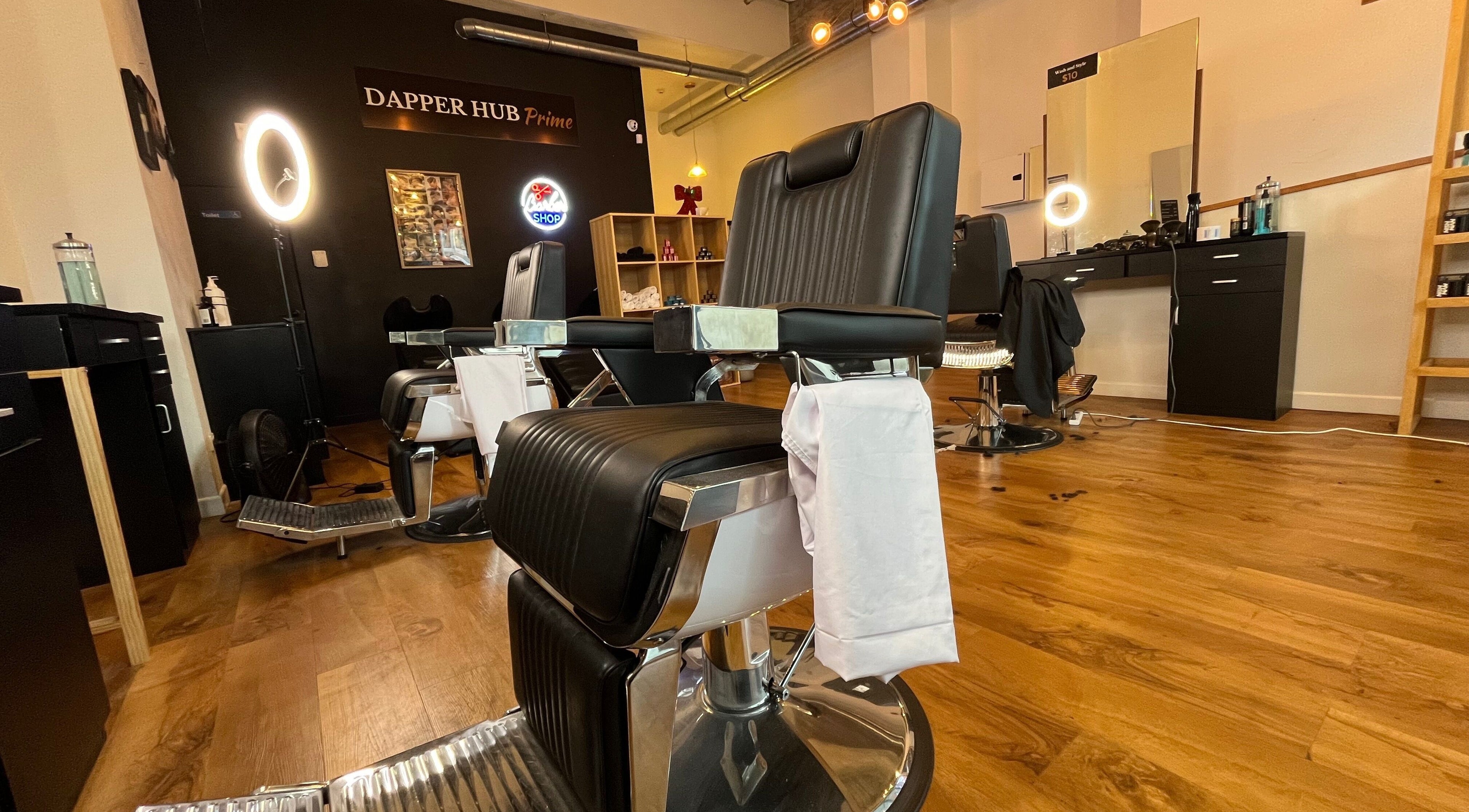 Interior of Dapper Hub Barbershop CBD in Auckland, Auckland, NZ showcasing stylish chairs and modern decor.