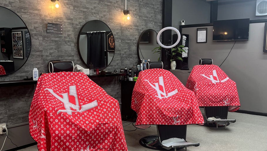 Trendy barbershop chairs at Dapper Hub Barbershop-PANMURE, Auckland, NZ with stylish red covers.