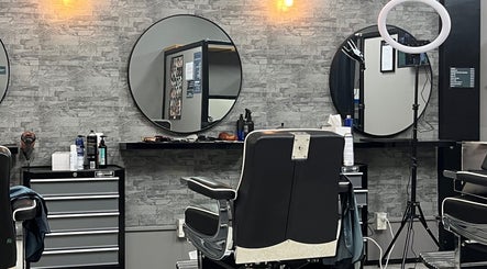 Modern interior of Dapper Hub Barbershop- PANMURE in Auckland, Auckland, NZ with sleek chairs and mirrors.