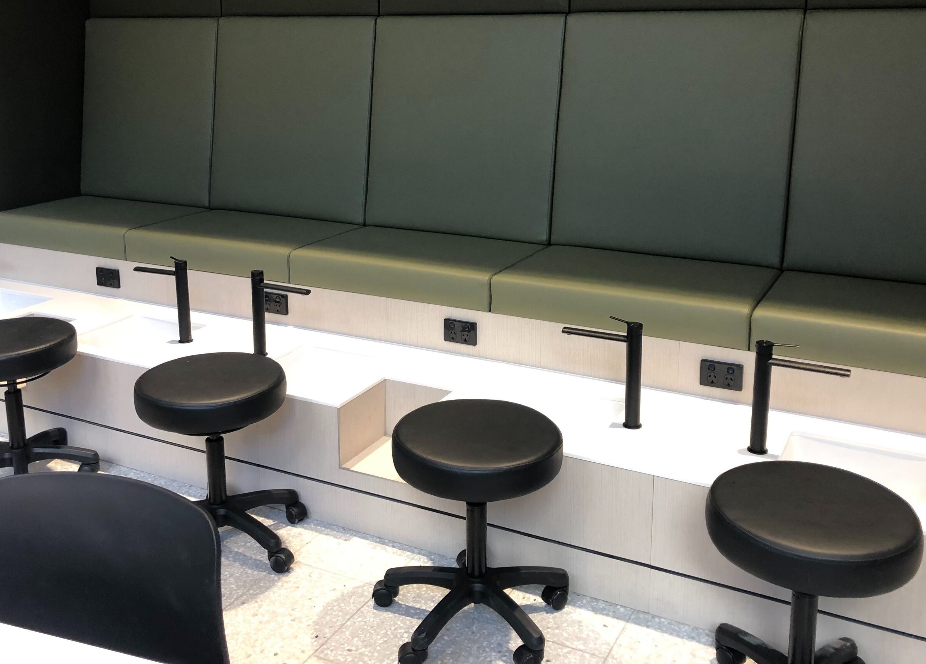 Modern nail station at Beauty Bar at David Jones, Sydney, New South Wales, AU, featuring sleek stools and basins.