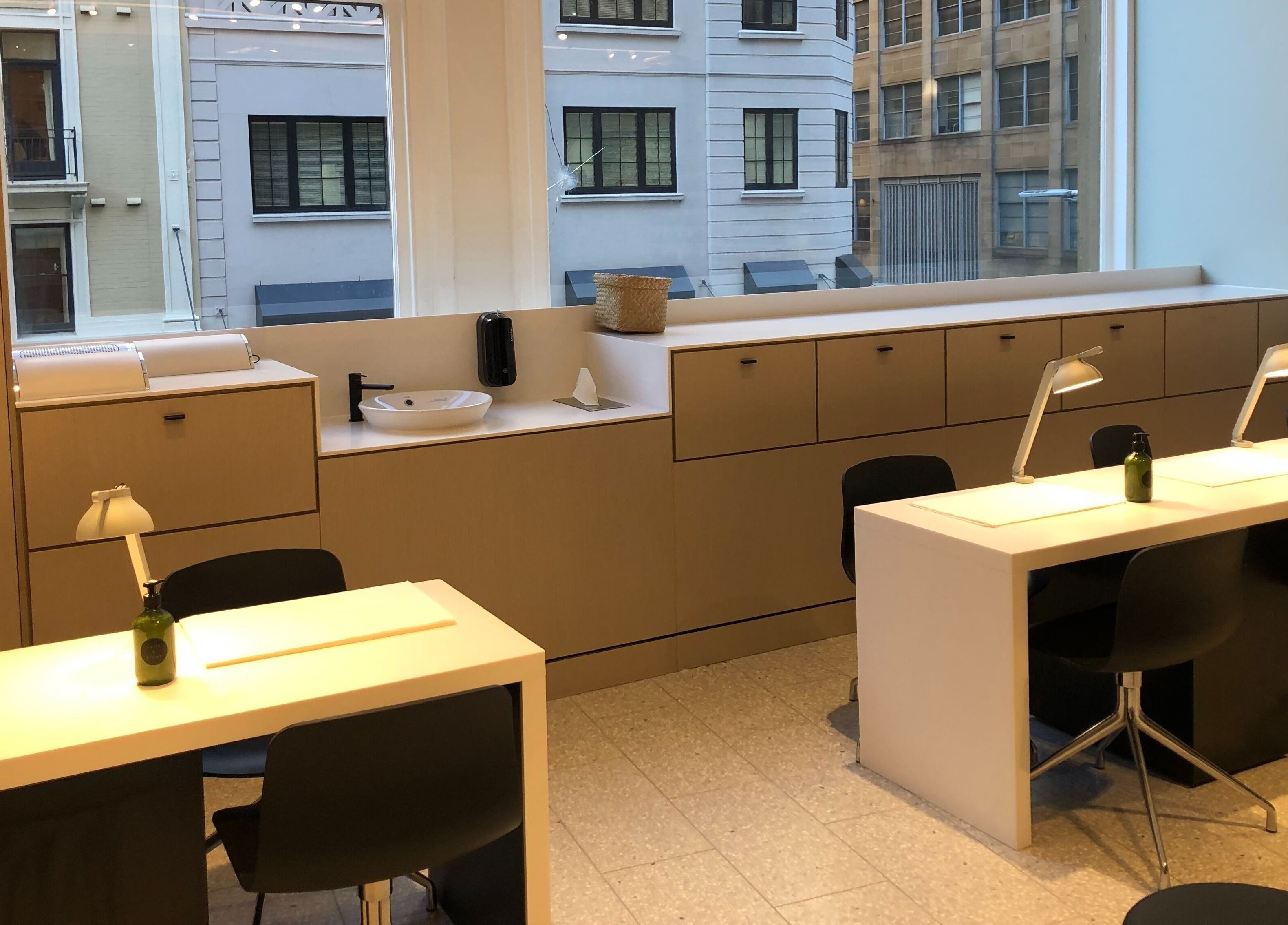 Modern nail stations in Beauty Bar at David Jones, Sydney, New South Wales, AU with large windows.