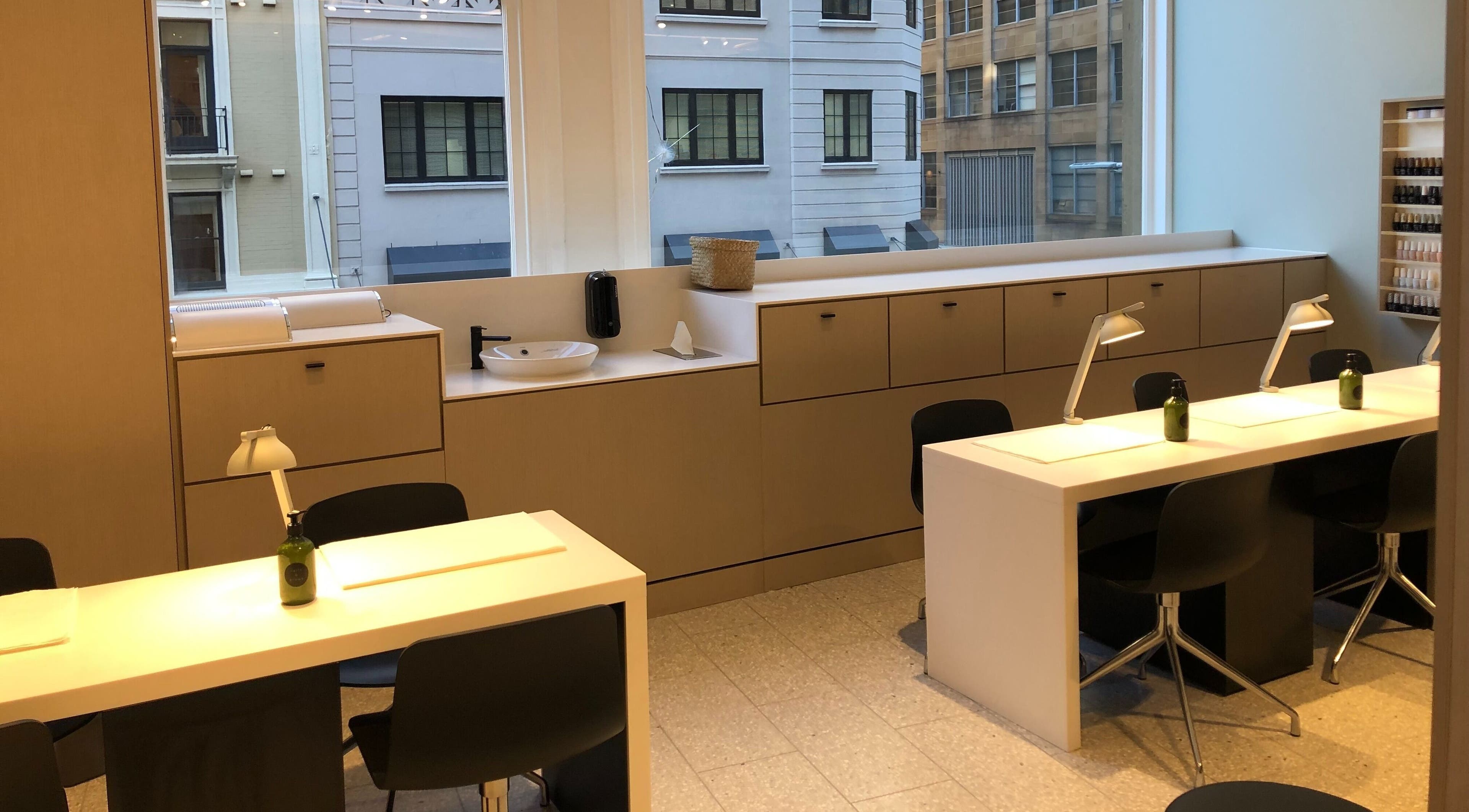 Modern nail stations in Beauty Bar at David Jones, Sydney, New South Wales, AU with large windows.