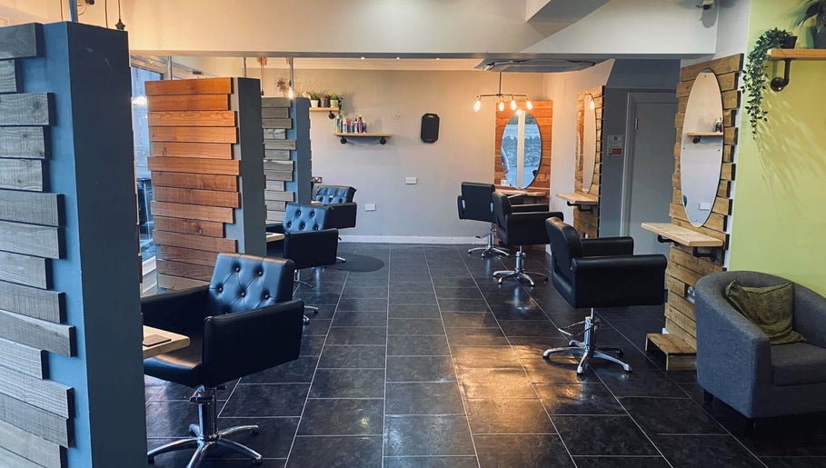 Modern salon chairs and mirrors at Hair At Rehab Limited in Kingsteignton, England, GB.
