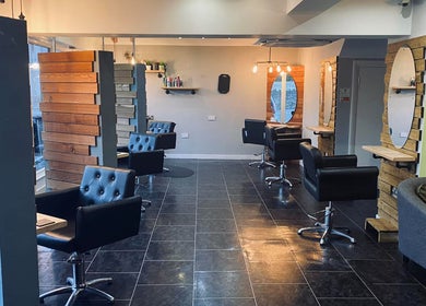 Modern salon chairs and mirrors at Hair At Rehab Limited in Kingsteignton, England, GB.