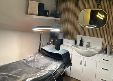 Relaxing treatment room at Hair At Rehab Limited in Kingsteignton, England, GB featuring a modern salon setup.