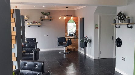 Modern salon interior at Hair At Rehab Limited, Kingsteignton, with stylish seating and decor elements.