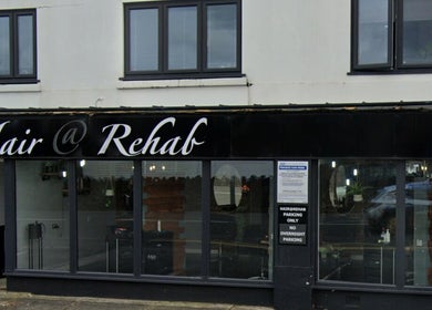 Exterior view of Hair At Rehab Limited in Kingsteignton, England, GB, showcasing modern salon design.