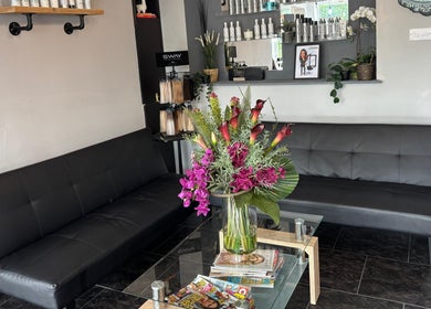 Inviting seating area at Hair At Rehab Limted, Kingsteignton, England, GB with floral decor and hair products.