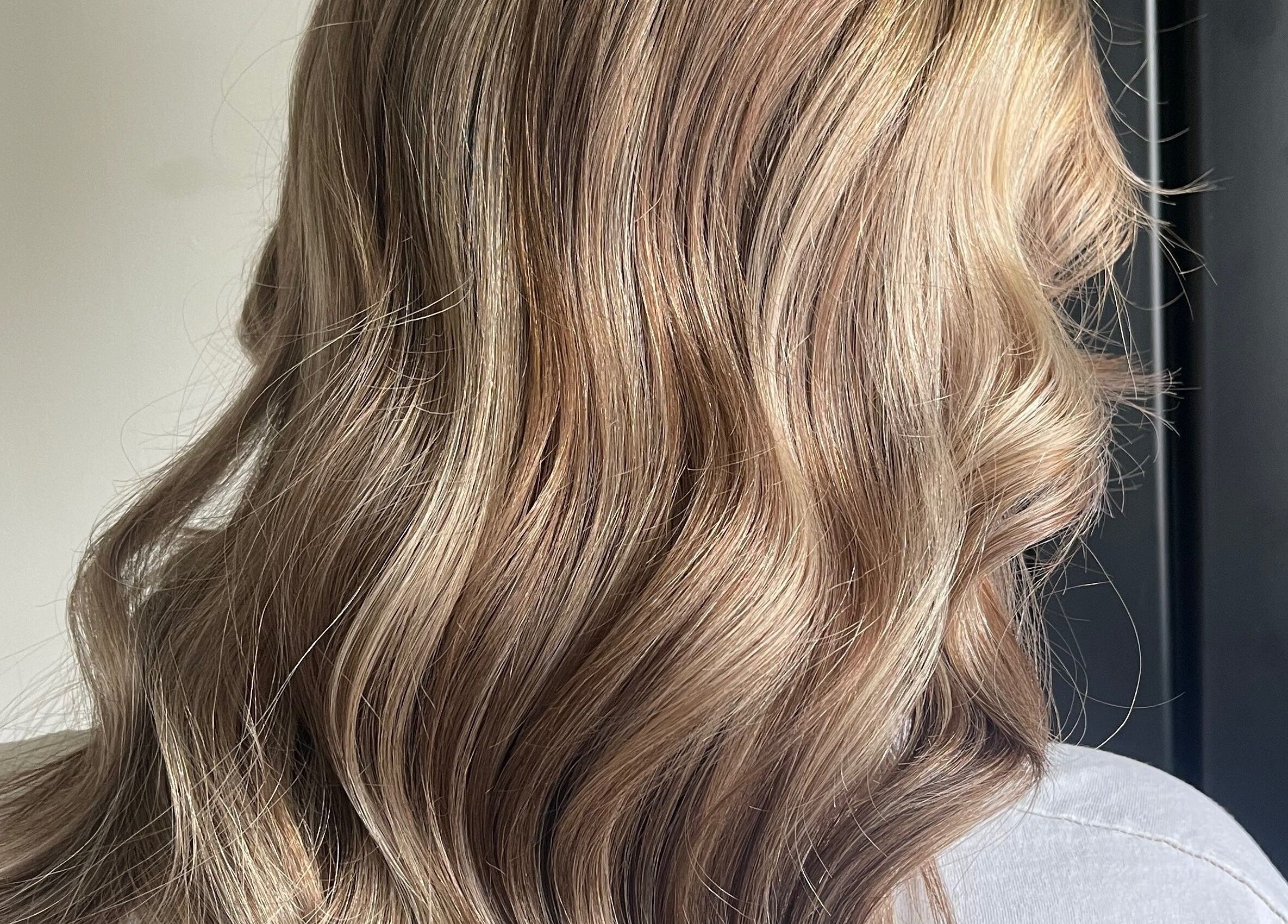 Soft, wavy blonde hair styled at Lily Of The Valley, Fremington, England, GB, showcasing natural beauty.