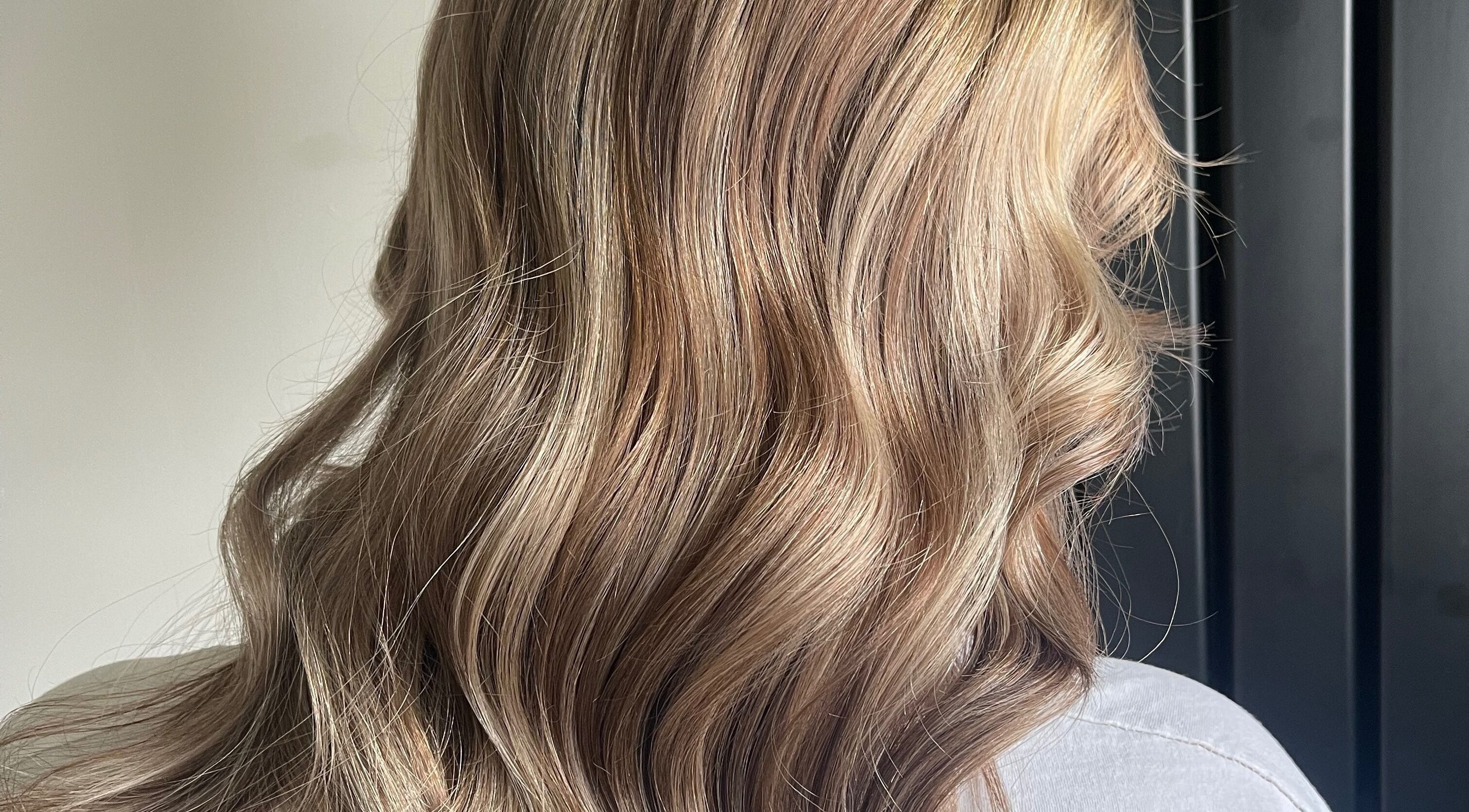 Soft, wavy blonde hair styled at Lily Of The Valley, Fremington, England, GB, showcasing natural beauty.