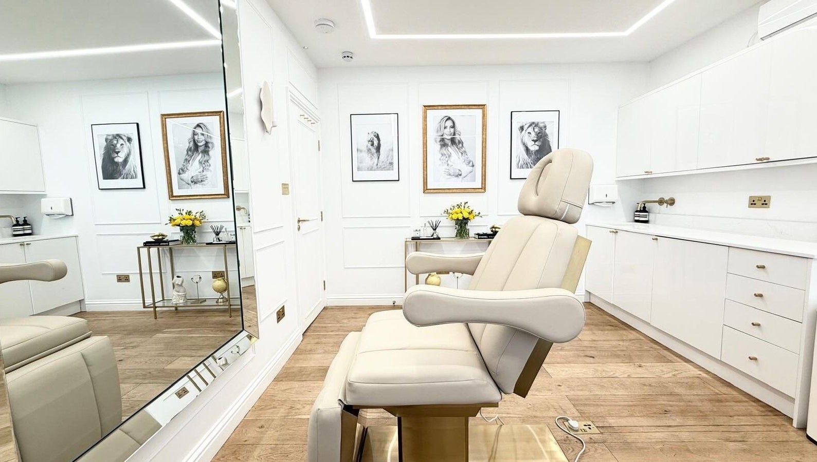 Sleek treatment room at Aesthetic by Maria, London, England, GB with modern decor and a comfortable chair.