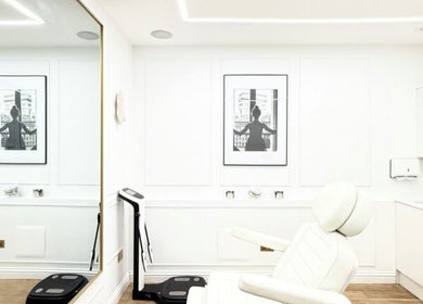 Aesthetic by Maria treatment room in London, England, GB with elegant white decor and reclining chair.
