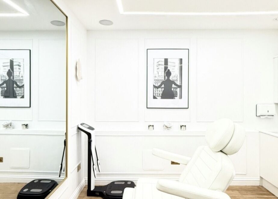Aesthetic by Maria treatment room in London, England, GB with elegant white decor and reclining chair.