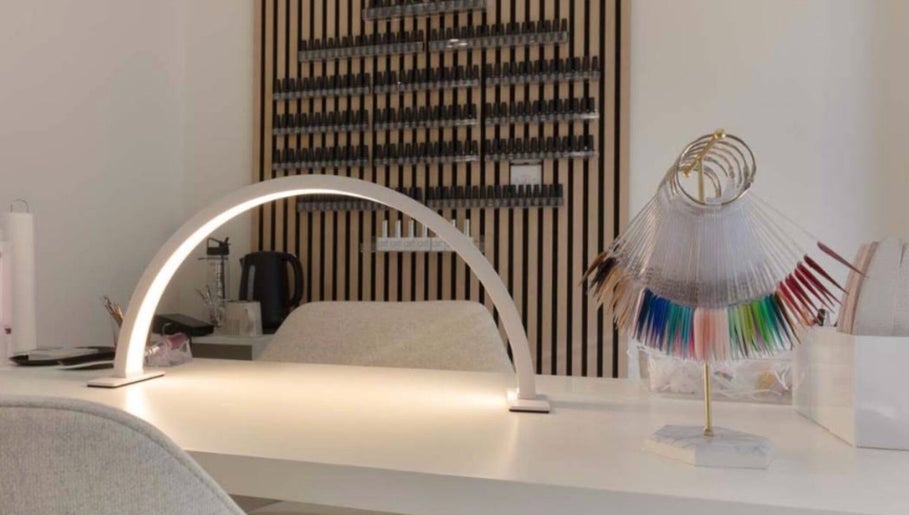 Modern nail station at Mais Nails in Barry, Wales, GB, showcasing vibrant nail colors on display.
