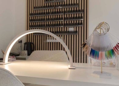 Modern nail station at Mais Nails in Barry, Wales, GB, showcasing vibrant nail colors on display.