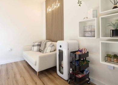 Relaxing reception area at Mais Nails, Barry, Wales, GB. Features a plush sofa and refreshment cart.