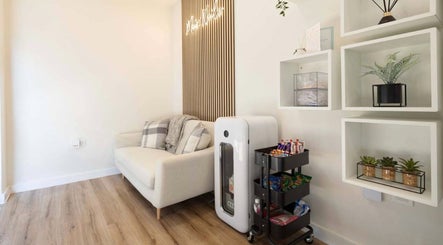 Relaxing reception area at Mais Nails, Barry, Wales, GB. Features a plush sofa and refreshment cart.