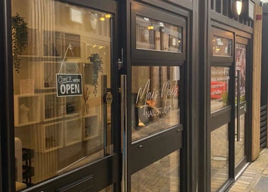 Entrance to Mais Nails in Barry, Wales, GB features a modern glass facade with open sign.