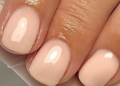 Glossy nude manicure at Mais Nails, Barry, Wales, GB, showcasing a chic and elegant style.