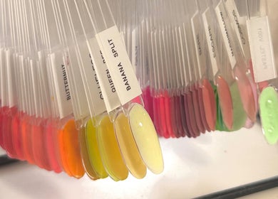 Nail color samples displayed at Mais Nails, Barry, Wales, GB. Diverse vibrant shades arranged neatly.