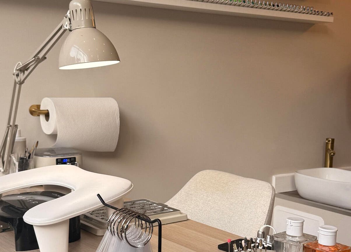 Modern nail station setup at Mais Nails in Barry, Wales, GB, featuring tools and a cozy ambiance.