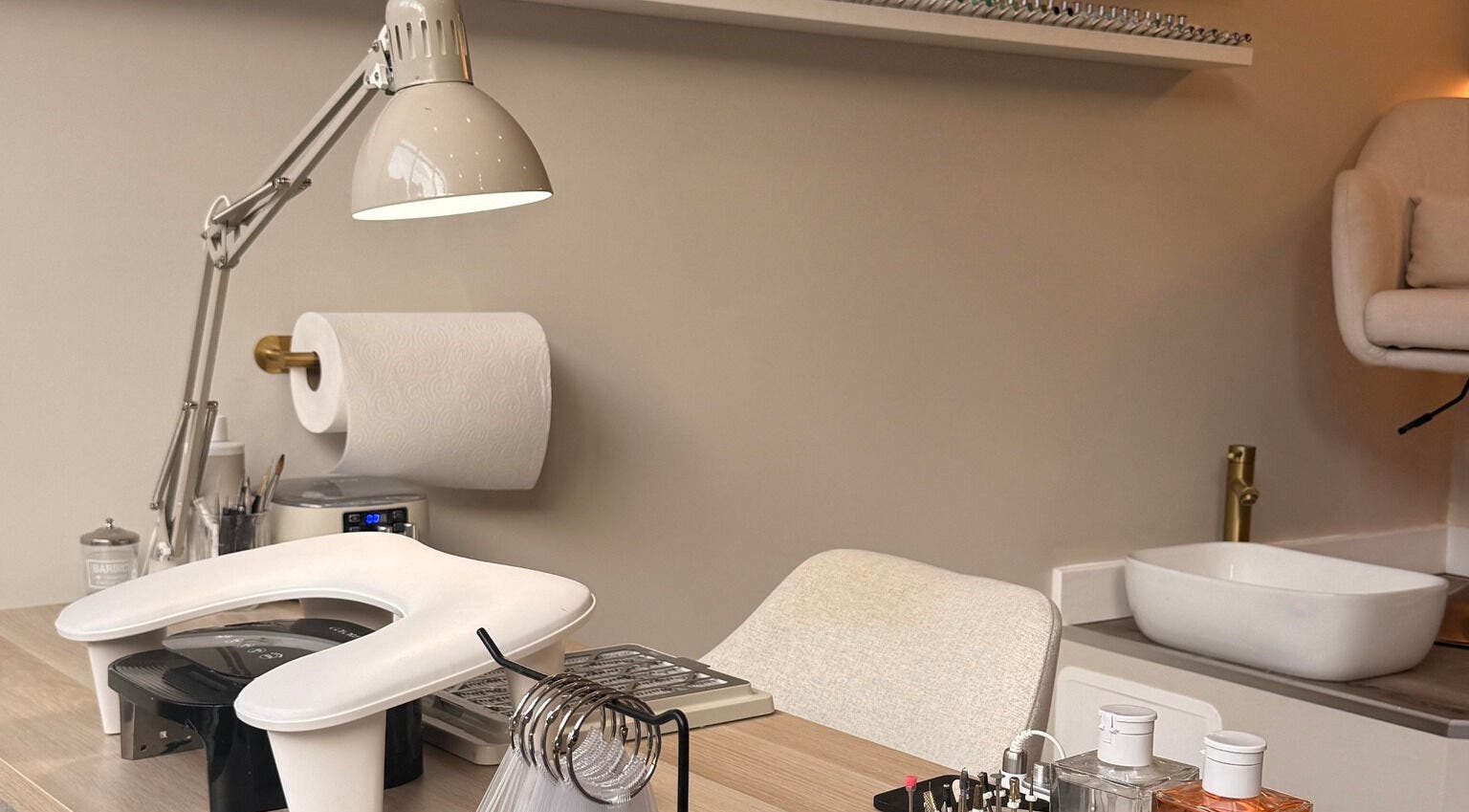 Modern nail station setup at Mais Nails in Barry, Wales, GB, featuring tools and a cozy ambiance.