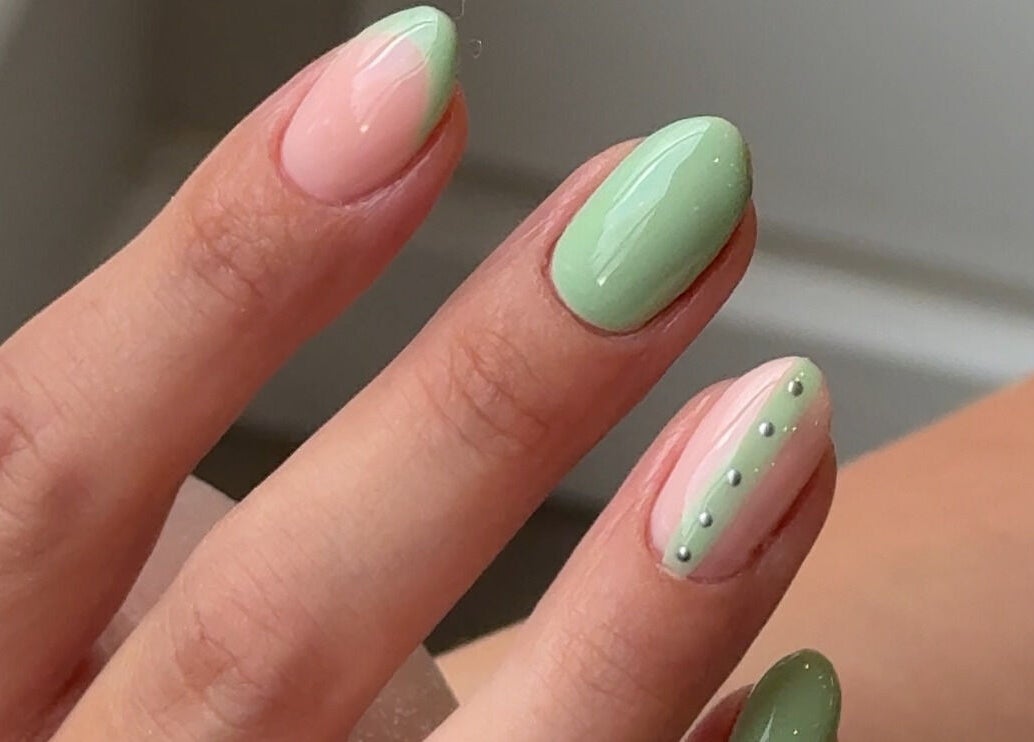 Detailed pastel nail art at Mais Nails, Barry, Wales, GB showcasing elegant green and pink designs.
