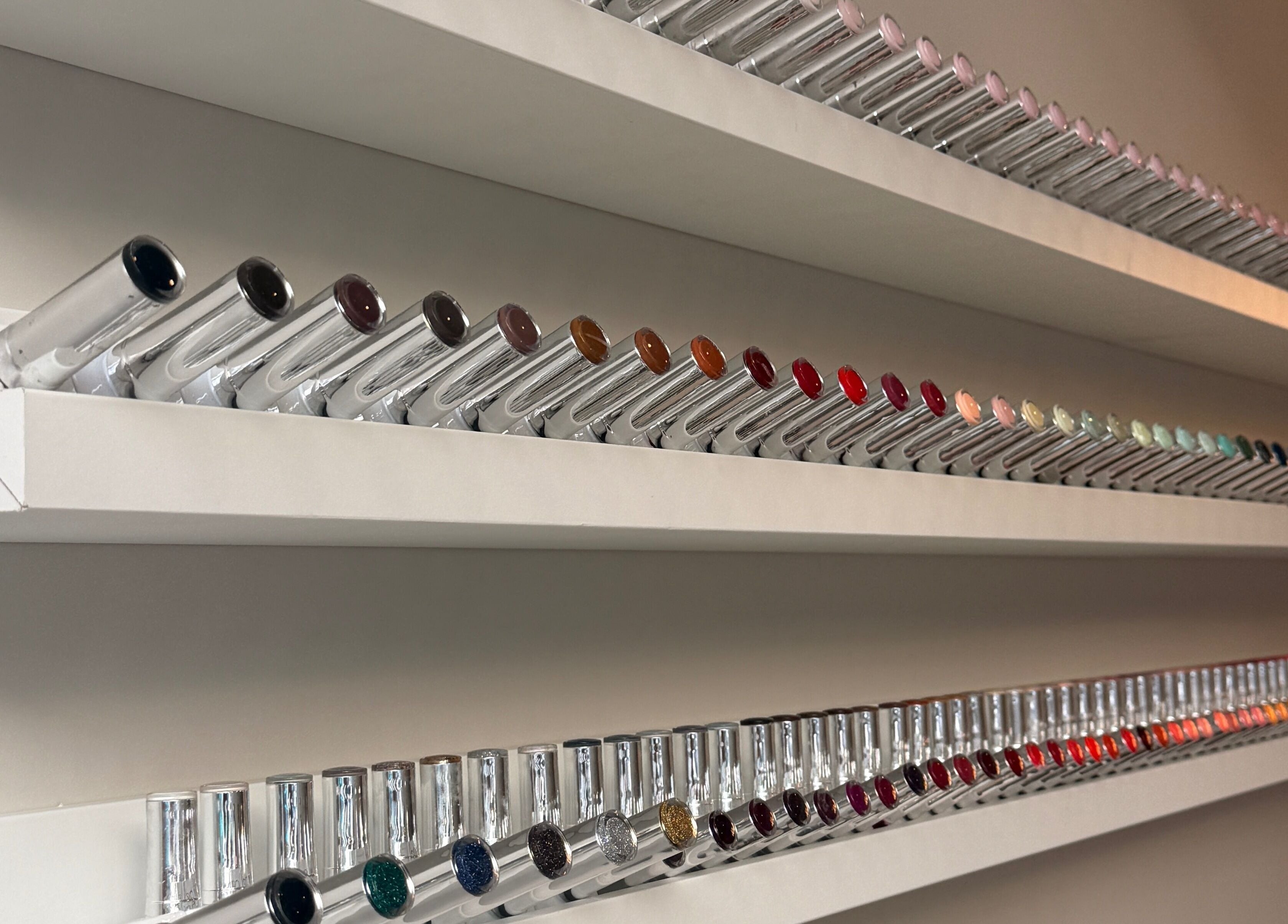 Colorful nail polish display at Mais Nails in Barry, Wales, GB showcasing a wide range of hues.