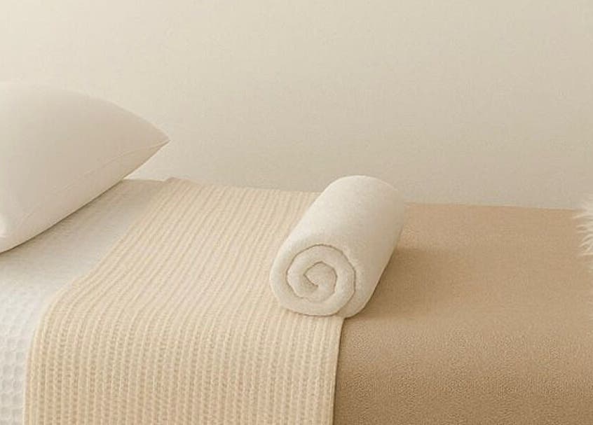 Relaxing massage table at LÚME HAUS Aesthetics, Wavell Heights, Queensland, AU, prepared with fresh towels.