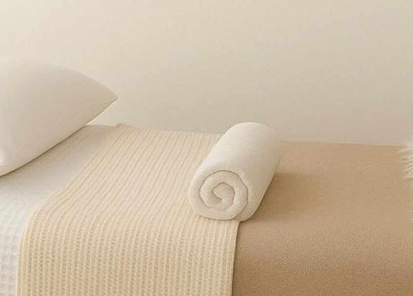 Relaxing massage table at LÚME HAUS Aesthetics, Wavell Heights, Queensland, AU, prepared with fresh towels.