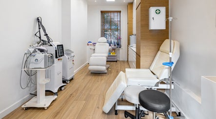 Modern wellness room at Crystal Medica, London, England, GB with advanced treatment equipment and reclining chairs.