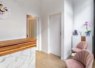 Reception area of Crystal Medica, London, England with marble counter and cozy seating.