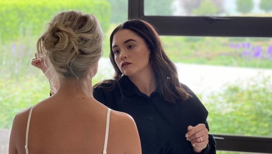 A stylist crafting a chic updo for a bride at Salon De Beauté, Bethlehem, Free State, ZA.