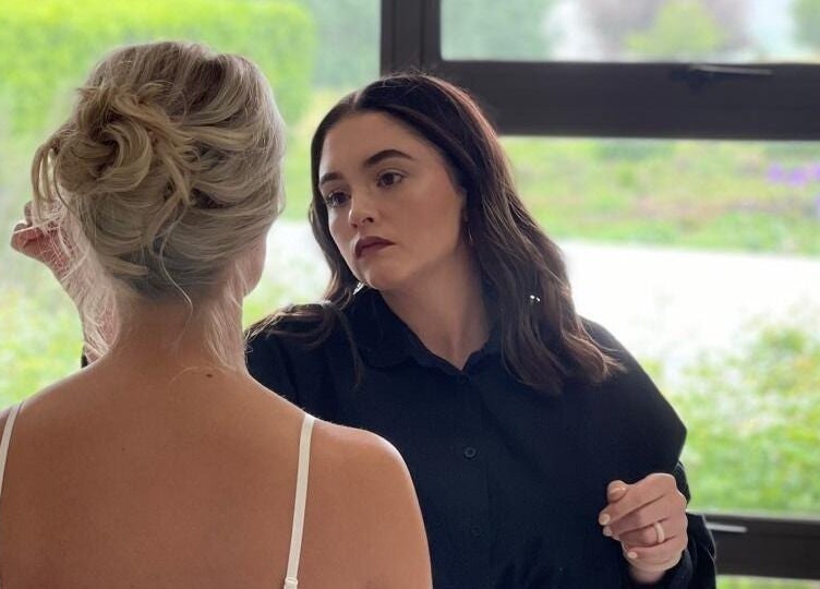 A stylist crafting a chic updo for a bride at Salon De Beauté, Bethlehem, Free State, ZA.