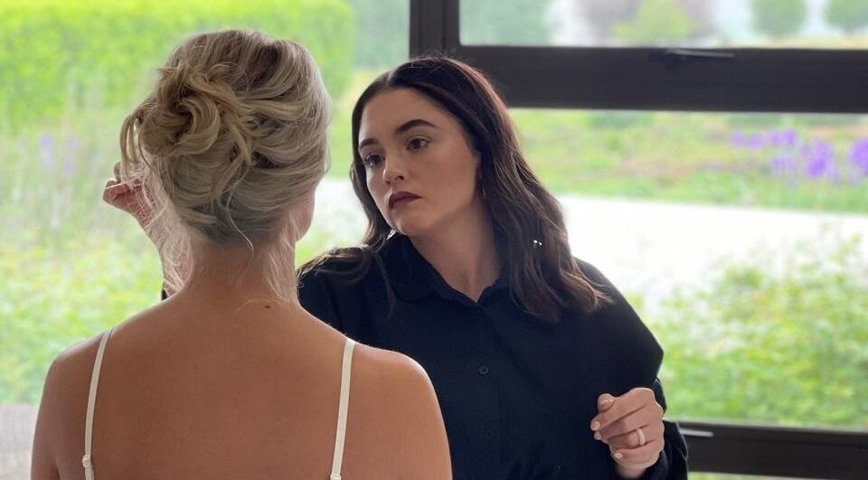 A stylist crafting a chic updo for a bride at Salon De Beauté, Bethlehem, Free State, ZA.