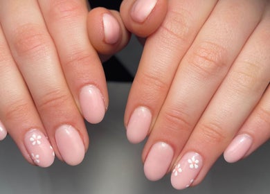 Elegant pastel pink nails with floral designs at Nails By Jade, Worthing, England, GB.