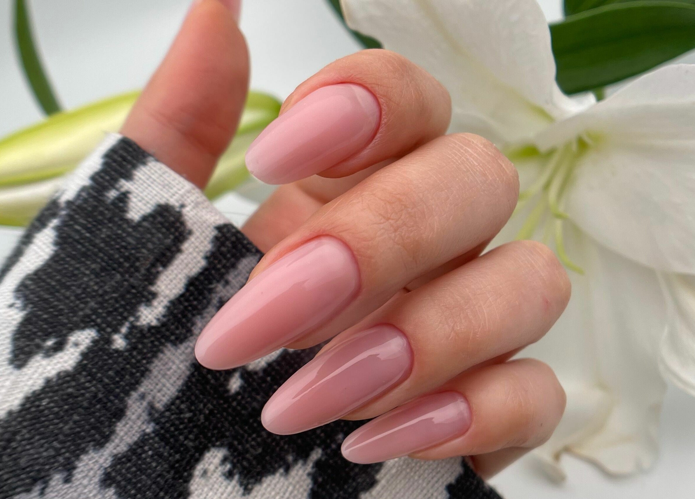 Elegant manicured hand with soft pink nails at Etc Boutique Spa Tahlia, Riyadh, SA.