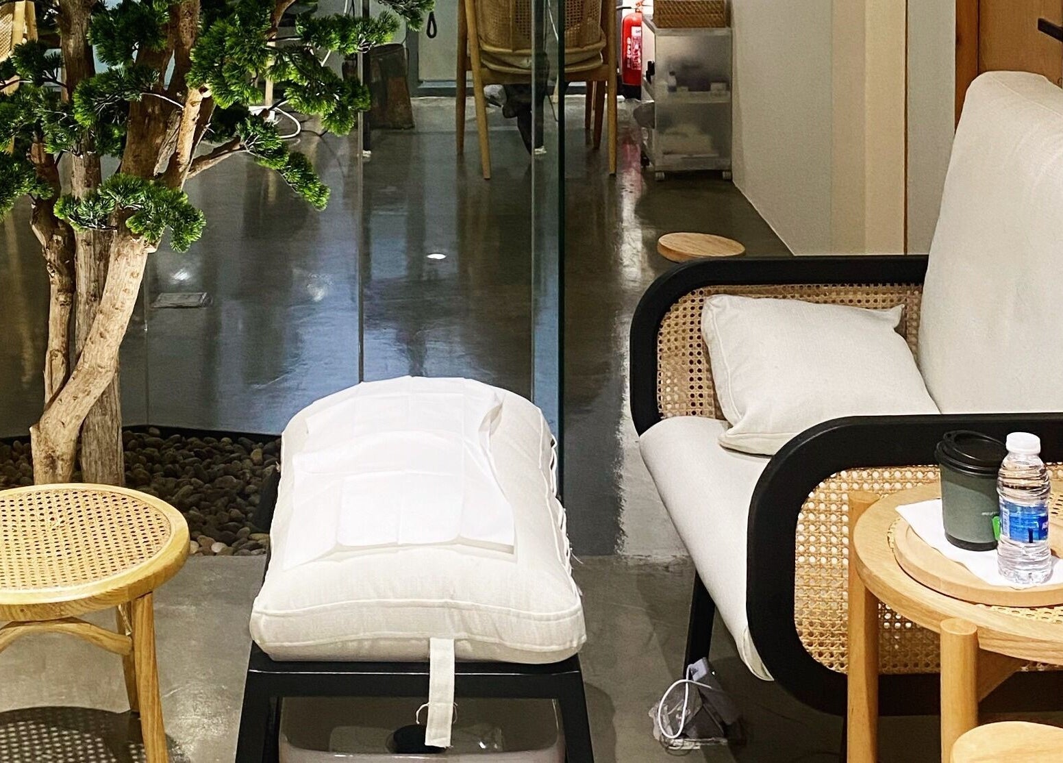 Inviting lounge at Etc Boutique Spa | Muhammadiyah, Riyadh, SA with a comfy chair, wooden table, and indoor plant.