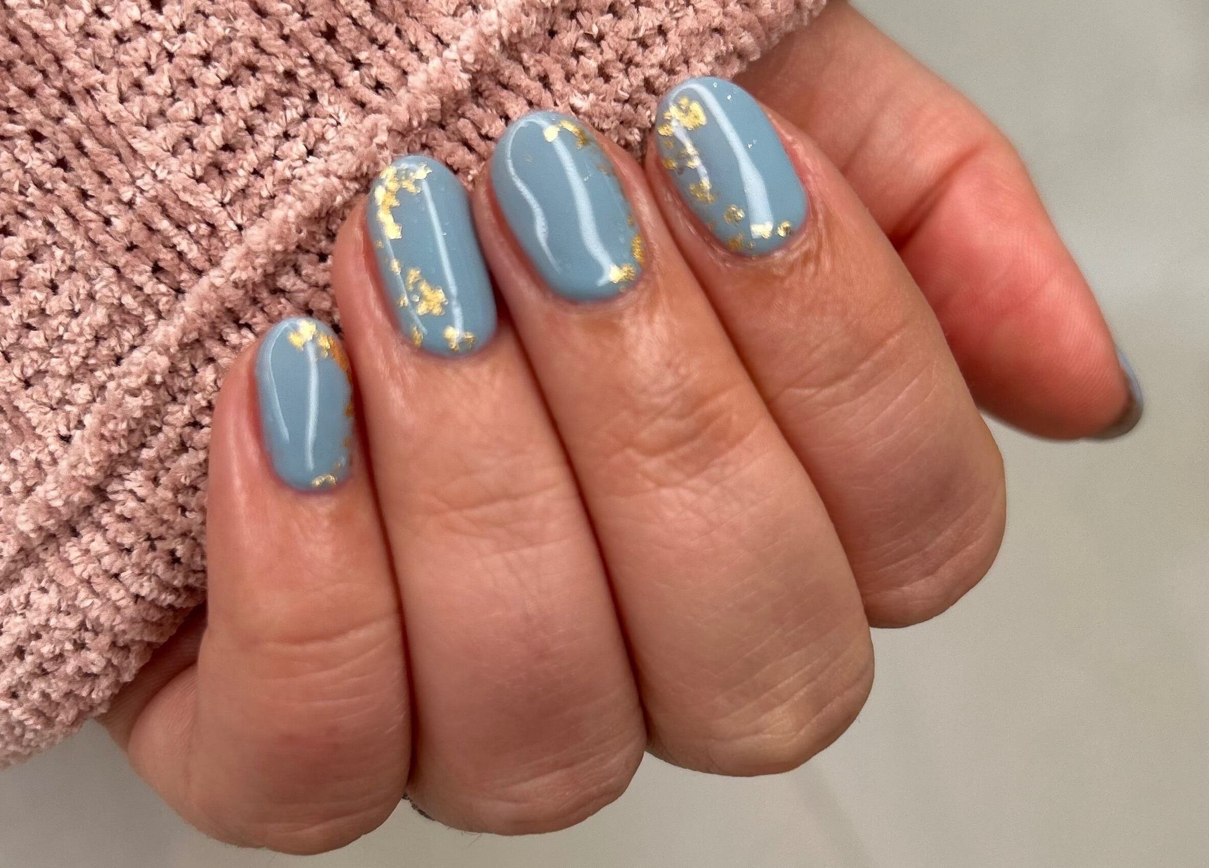 Elegant blue manicure with gold accents at Cove Beauty Co, Poole, England, GB.