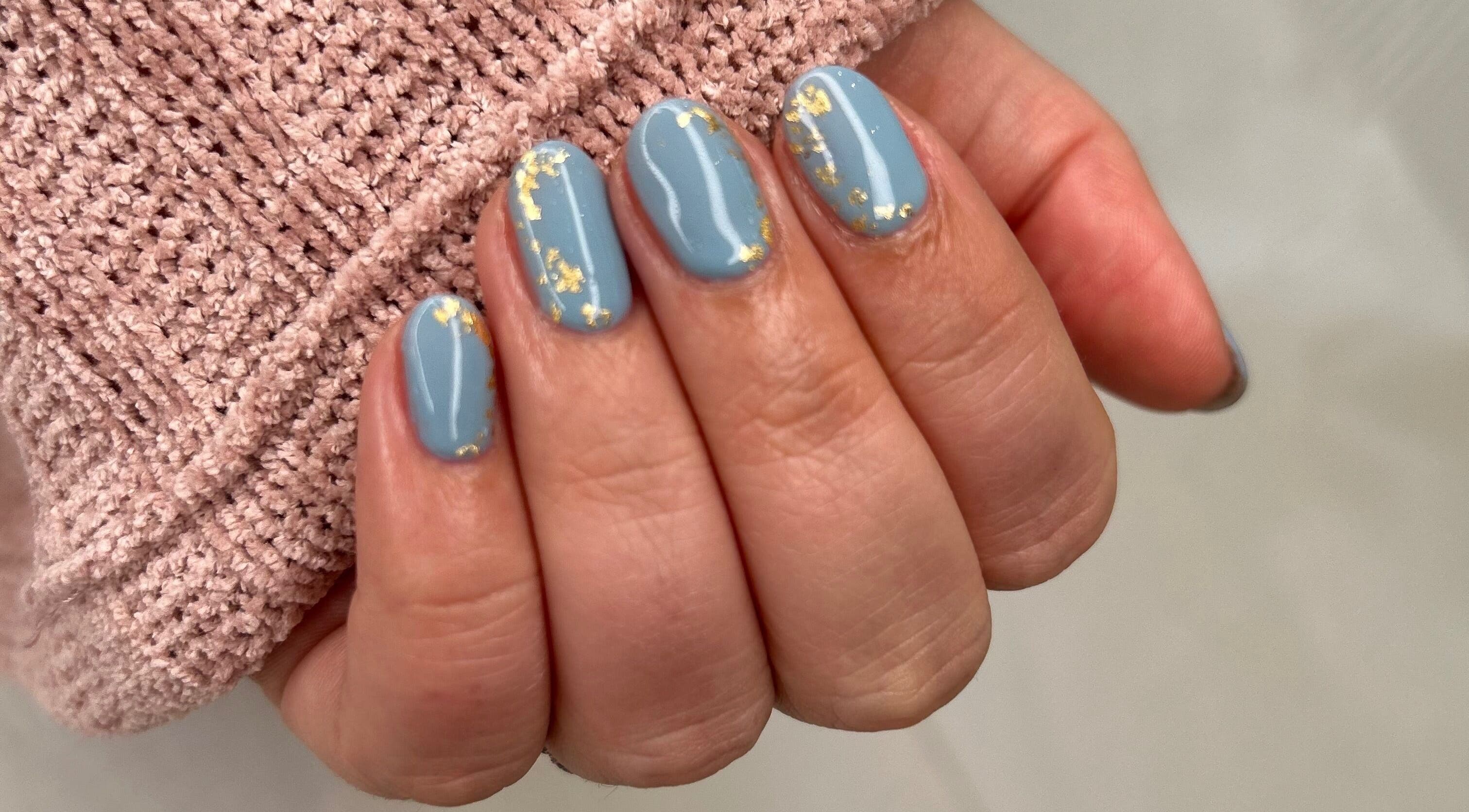 Elegant blue manicure with gold accents at Cove Beauty Co, Poole, England, GB.
