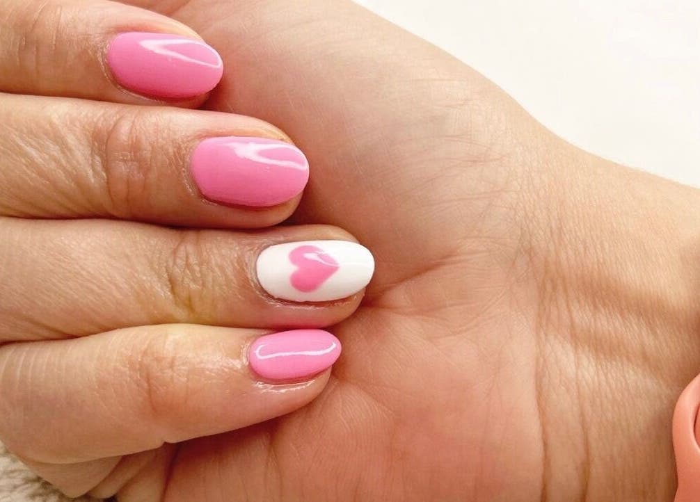 Pink nail design with heart accent at Cove Beauty Co, Poole, England, GB.