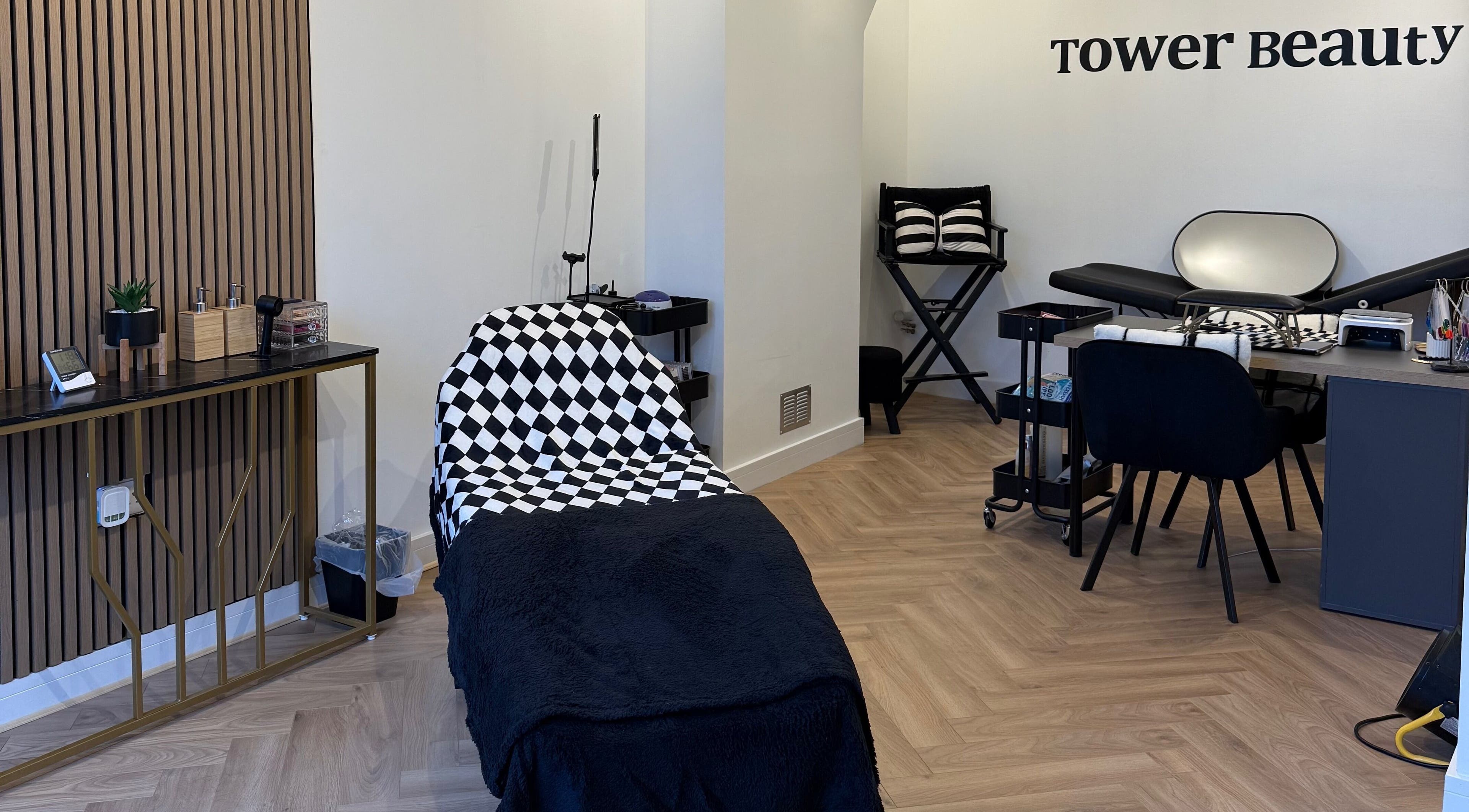 Interior of Tower Beauty HQ in Stoke-on-Trent, England, featuring a stylish treatment area with modern decor.
