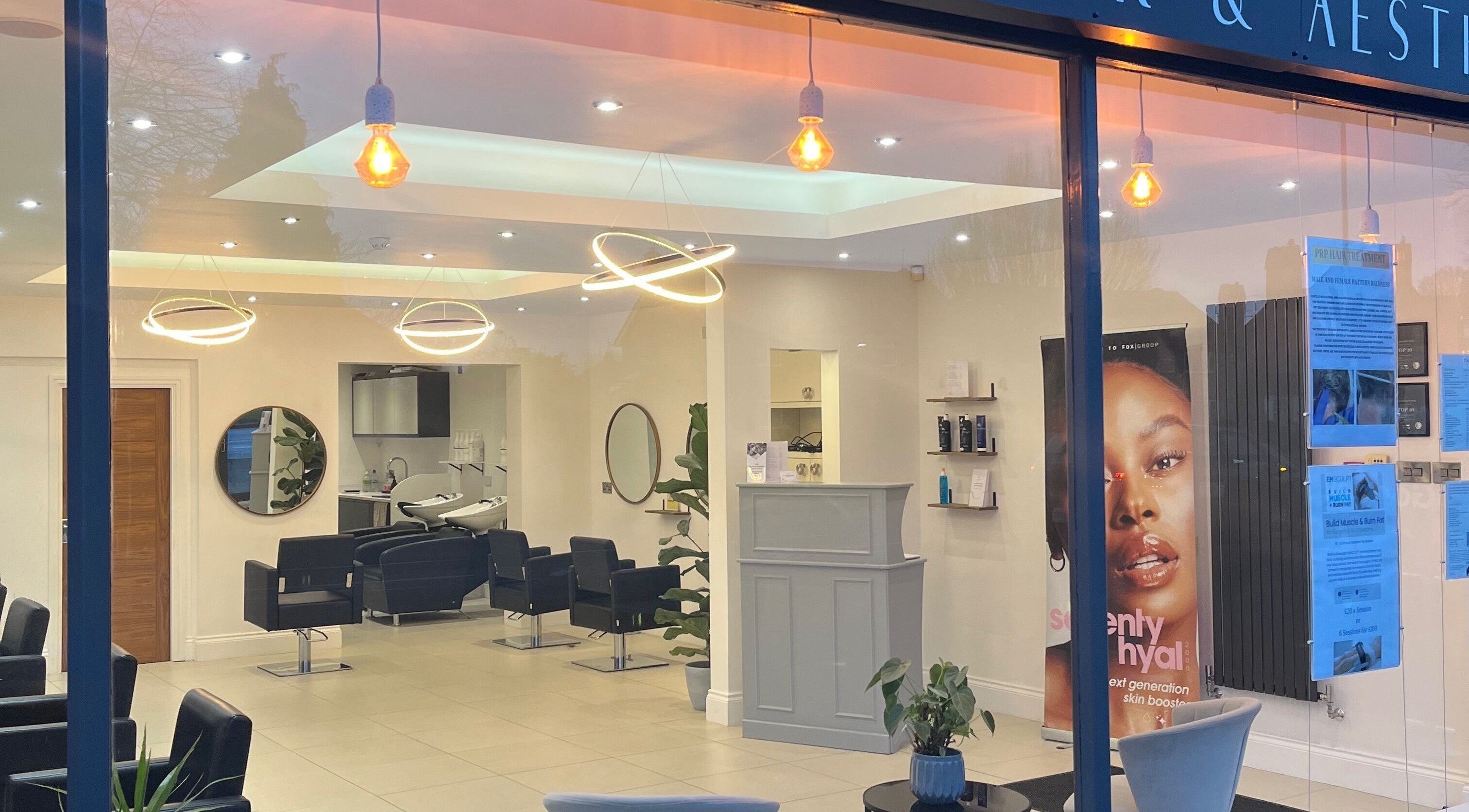 Elegant interior of D.H Hair & Aesthetics in Willerby, England with modern decor and styling stations.