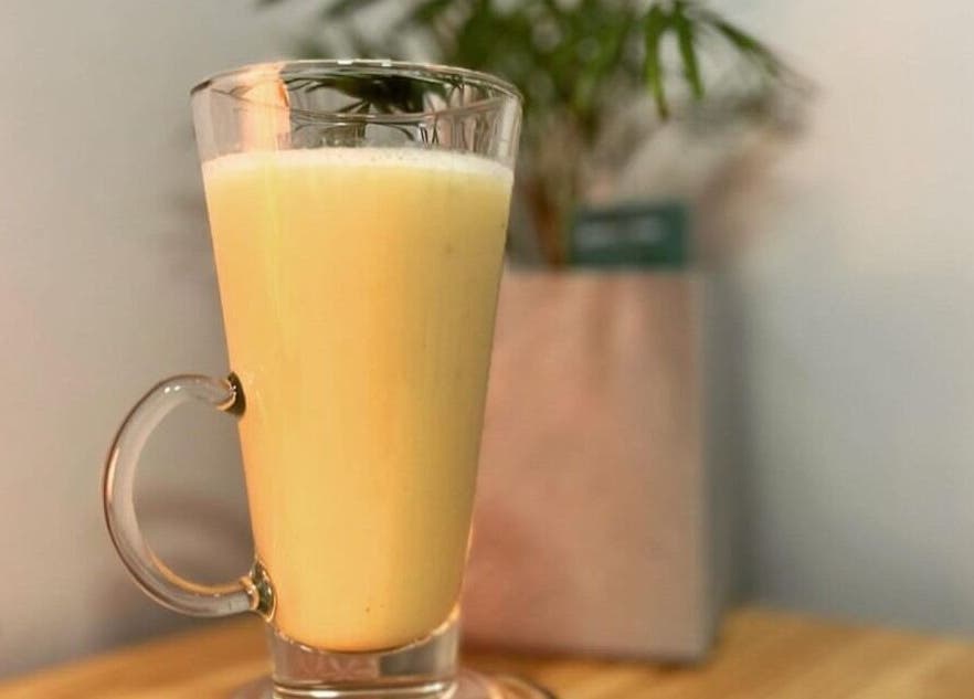 Creamy beverage served at Chill & Tonic at The Granary, Polesworth, England, GB, on a wooden table.