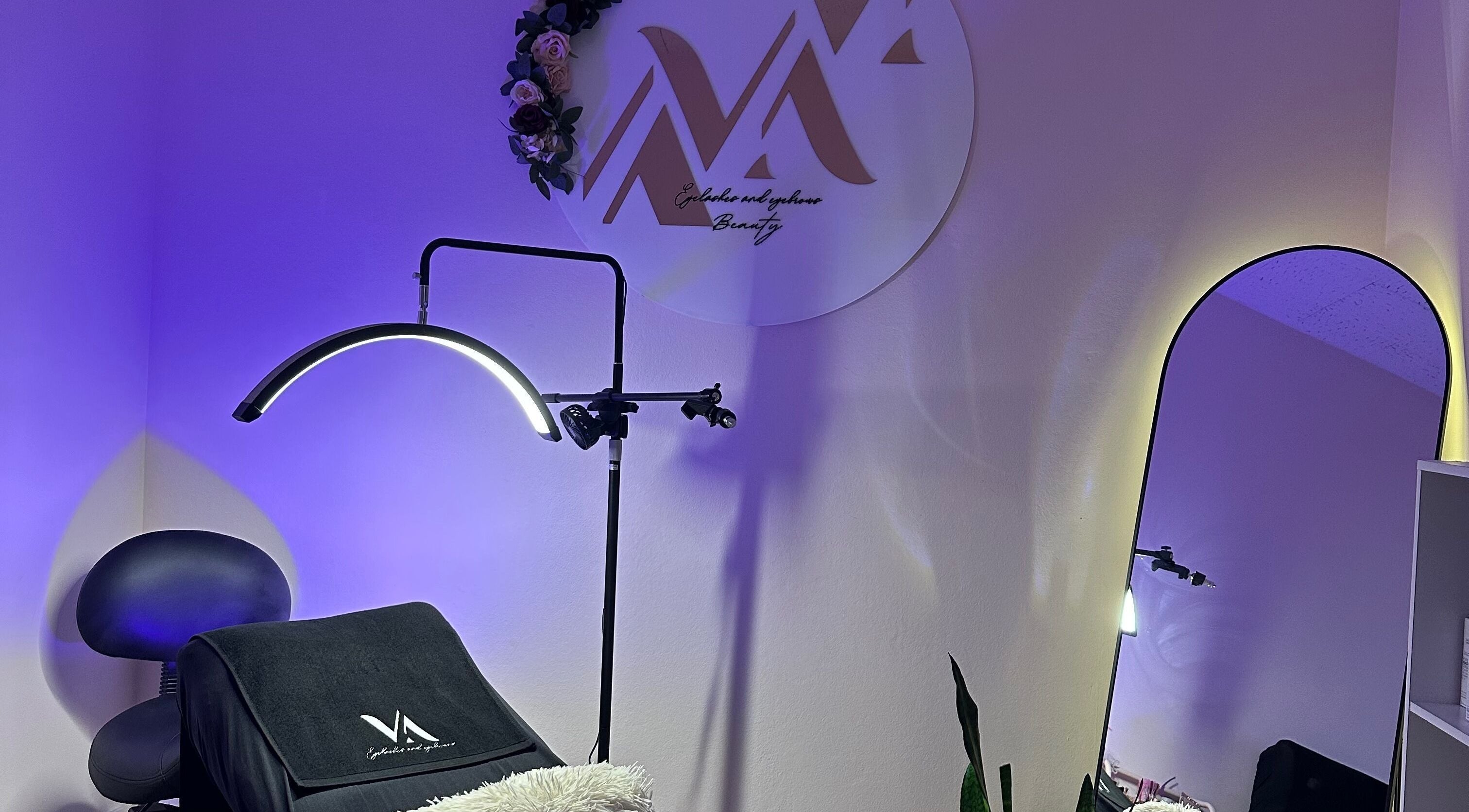 Cozy salon corner at VA Eyelashes & Eyebrows in Newtown, New South Wales, AU with elegant lighting and decor.