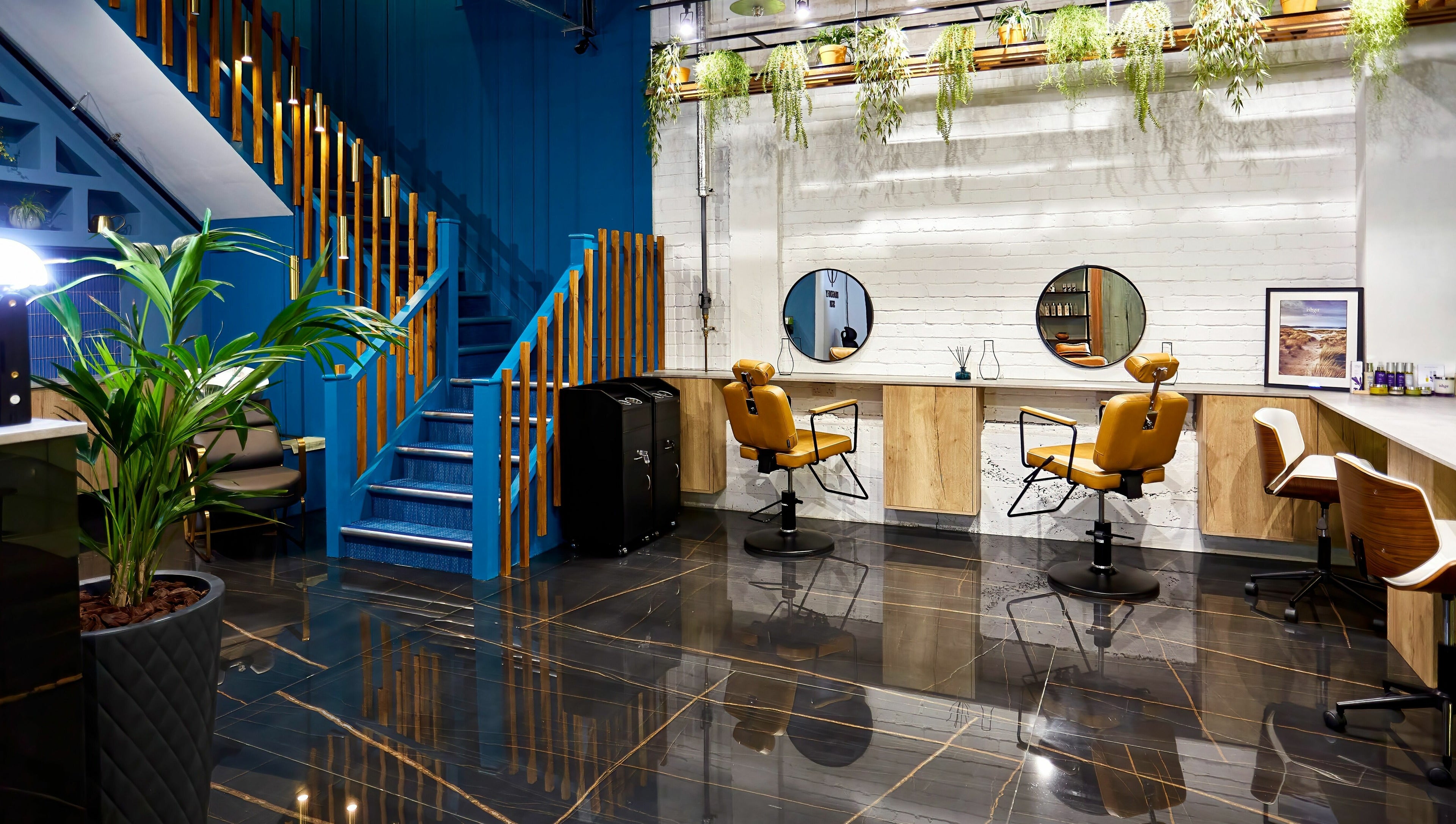 Stylish salon interior at Dragonfly Skin Day Spa, Leeds, England, GB with sleek chairs and lush plants.